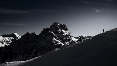 Mountaineers in front of the summit of the Großer Widderstein in winter, Baad, Vorarlberg, Austria,