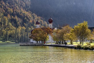 Pilgrimage church St. Bartholomä in autumn at Königssee, autumnal mountain landscape at the lake,