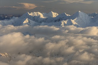 Aerial view of the Alaska Range above clouds, evening light, Alaska, USA, North America