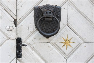 White door with door knocker, donkey, street with old colourful wooden houses, Naantali or