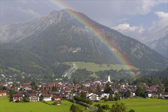 View over Oberstdorf with rainbow, behind it the Schattenberg, 1845m, Oberallgäu, Bavaria, Germany,