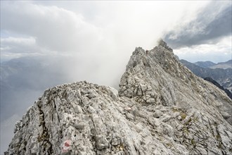 Clouds around a narrow rocky ridge, Watzmann crossing to Watzmann Mittelspitze, view of mountain