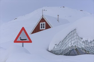 Warning sign for sledges in front of a snow-covered house, winter, Tasiilaq, East Greenland,