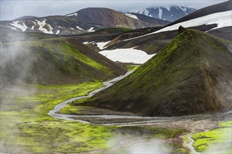 Colourful volcanic landscape with hills and snow, volcanic steaming hot springs, Laugavegur