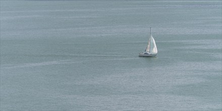 Sailing boat on the turquoise waters of Lake Constance, near Meersburg, Baden-Württemberg, Germany,