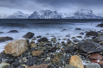 Stones, coast, sea, waves, mountains, winter, snow, cloudy, windy, long exposure, Lyngen Alps,