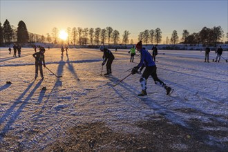 People playing ice hockey on a lake, evening light, sunbeams, Staffelsee, Murnau, foothills of the