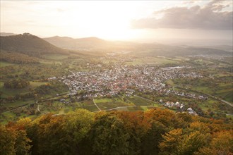 Beautiful sunset in autumn on the Beurener Fels with a view of Beuren and Hohenneuffen Castle