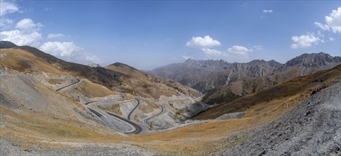 Winding roads on the Pamir Highway, mountain road through an eroded mountain landscape, Kyrgyzstan,