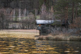 House on the lake with perfect reflection in front of a mountain panorama in the background, Thum