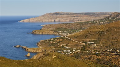 View of a coastal village with traditional architecture between mountains and sea, south coast,