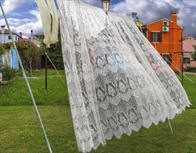 Typical Burano lace embroidery on the washing line, Burano, Venice, Italy, Europe