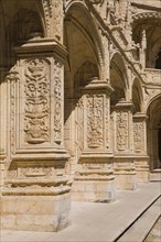 Old building with columns and arches decorated with architectural details in the inner courtyard at