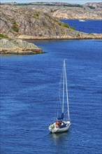 Sailboat at sea by a rocky archipelago on the Swedish west coast, Hamburgsund, Bohuslän, Sweden,