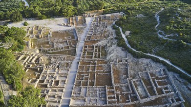 Drone shot, first morning light, aerial view of an ancient site, remains of walls and structures