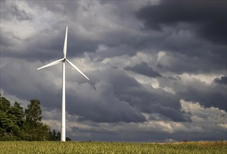 Wind turbine in front of dark storm clouds near Waldmössingen in the Black Forest. Wind energy.