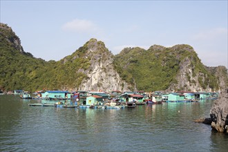 The floating fishing village of Cai Beo and the karst rocks in Lan Ha Bay, Halong Bay, Vietnam,