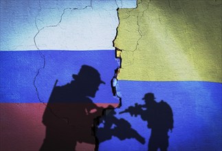 Russia vs Ukraine flag on cracked wall, concept of war between russia and ukraine, silhouette of