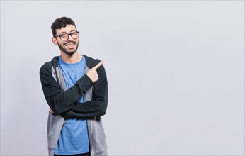 Smiling people pointing a banner to the side isolated. Happy young man pointing fingers to the