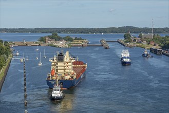 Cargo ship waiting in front of the lock, tugboat, Kiel Canal, Holtenau, Kiel, Schleswig-Holstein,