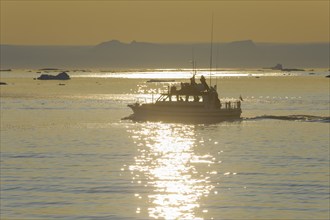 Excursion boat on fjord Ilulissat, Icefjord, Disko Bay, Qaasuitsup, Greenland, Polar Regions,