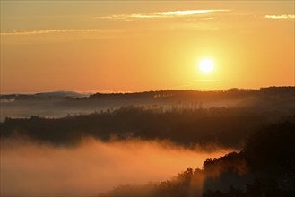 Sunrise, fog rising over the Arnsberg Forest nature park Park, North Rhine-Westphalia, Germany,