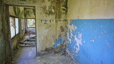 Dilapidated blue walls and windows in an abandoned building showing signs of decay, Lost Place,