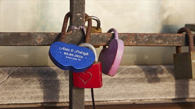 Personalised love locks, one in the shape of a heart, on a railing, harbour area, Rhodes Town,