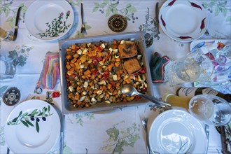 Mixed vegetables with fried cheese on a baking tray on a laid table, Bavaria, Germany, Europe