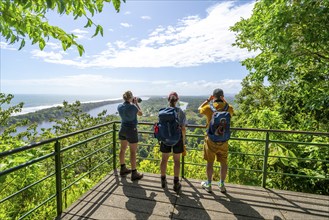 Tourists look out over the rainforest from Cerro Tortuguero, Tortuguero National Park, Costa Rica,