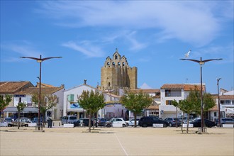 Market square with parked cars in summer, Saintes-Maries-de-la-Mer, Camargue, France, Europe