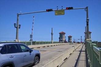 Traffic light, drawbridge and a car, with a sign, Bridge of Lions, pointing to a drawbridge, St.