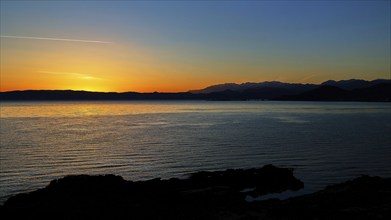 Gulf of Kissamos, sunrise over the sea with a calm and peaceful atmosphere, the mountains are