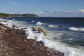 Rocks and waves meet a rocky coastline under a clear blue sky, Tönsberg, Oslofjord, Norway, Europe