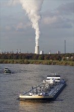 Barge on the Rhine near Duisburg-Laar, column of smoke above the cooling tower of the Thyssenkrupp