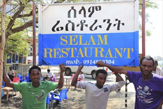 In a village in the highlands between Mekele and Lalibela, advertising sign for a restaurant, young