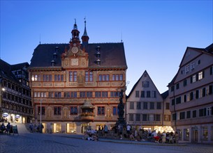 Historic town hall, illuminated, Neptune fountain, market square, in summer, people relaxing in