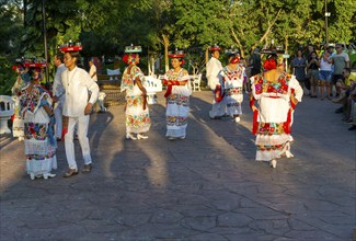 Folk dancers with drink trays balanced on their heads, Francisco Cantón Rosado Park, Valladolid,