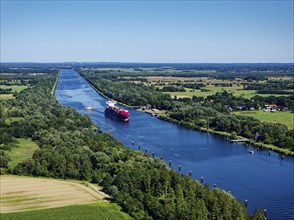 Aerial view of the Kiel Canal near Oldenbüttel, looking north-east. A container freighter is