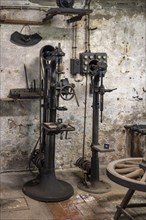 Old stationary drilling machines in a historic forge, workshop with museum, Salem Castle, former