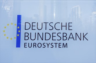 DEUTSCHE BUNDESBANK EUROSYSTEM logo on a glass surface featuring European stars and blue stripe,