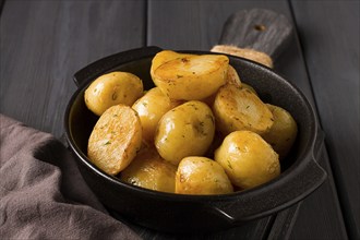 Fresh Cooked, new potatoes, with dill, on a wooden table, selective focus. close-up, toning, no