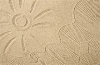 Drawing on sand, sun, waves, top view, no people, summer, vacation, travel