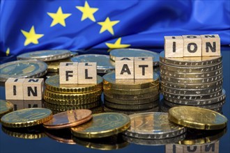 Symbolic image of inflation: euro coins and letters displaying the word INFLATION