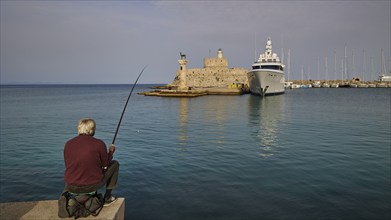 A Fish at a harbour with a clear view of a fortress and a standing yacht during the day, Fort of