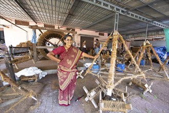 Indian worker, 59 years old, in the spinning mill of the Labourers Coir Mats and Mattings