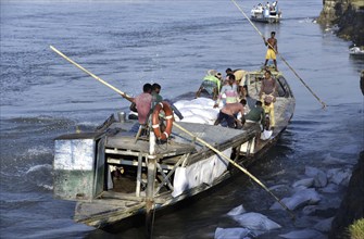 Public Works Department (PWD) of Assam labourer throwing sand bag from boat in the banks of Beki