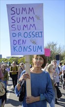 Demonstrator with sign Summ, summ, drosselt den Konsum at the 14th Global Climate Strike of Fridays