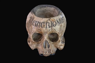 Holy water vessel in the shape of a skull, marble, 17th century, on a black background,