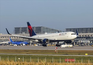 Stuttgart Airport with terminal, Delta Air Lines aircraft landing. Boeing 767-300. Stuttgart